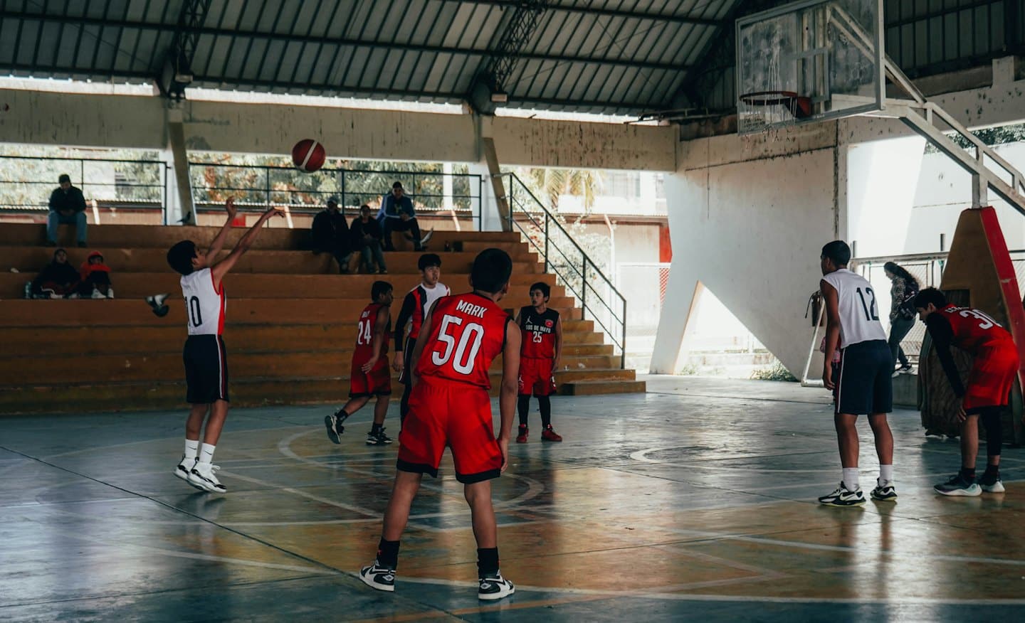 Young athletes playing basketball during a game.