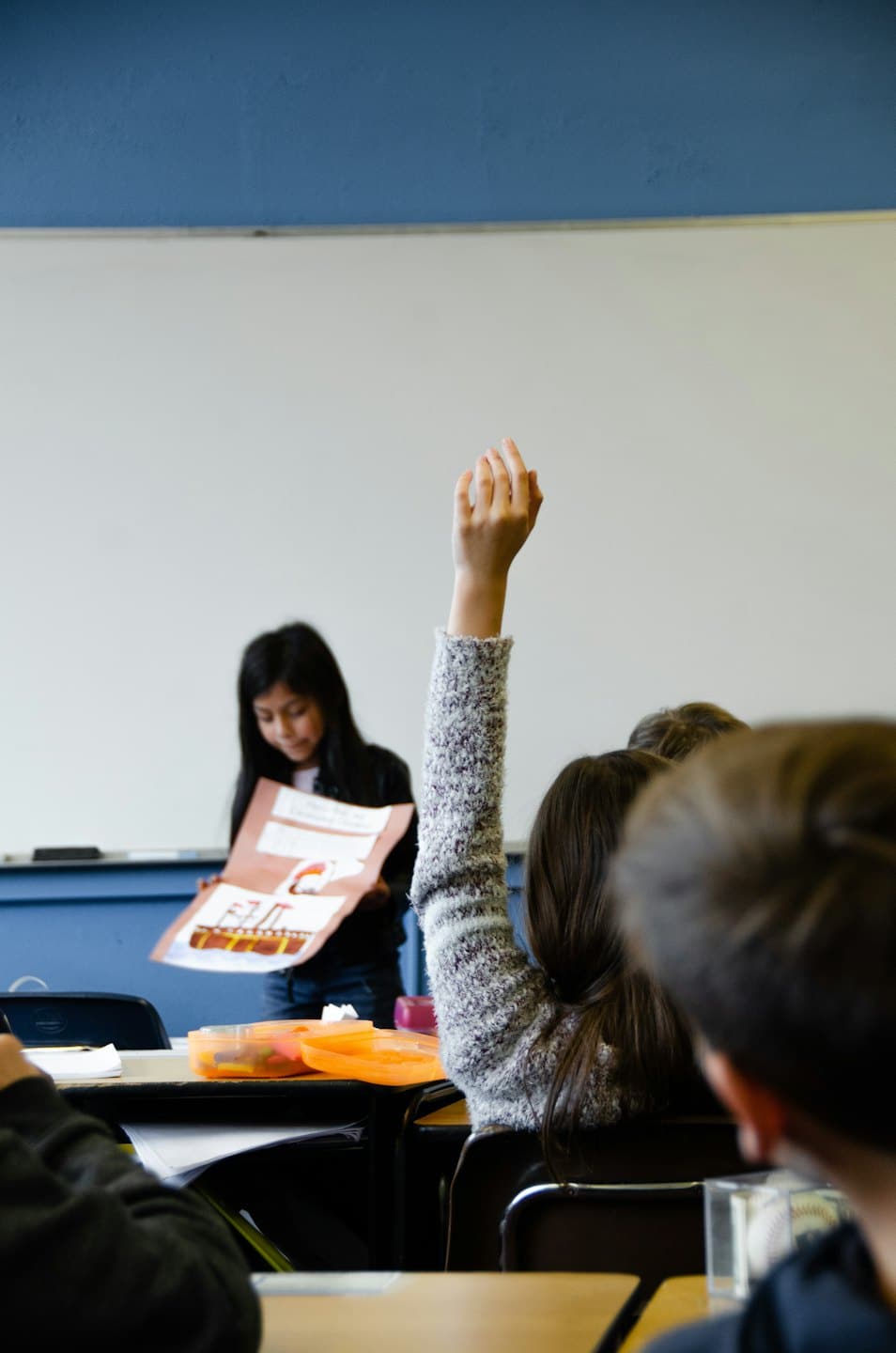 Student presents a project at the front of a classroom.